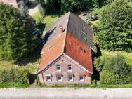 Teilvermietetes Zweifamilienhaus mit Nebengebäude sowie Wald- und Seegrundstück - Großefehn