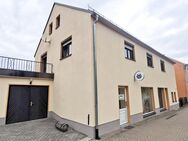 Einfamilienhaus mit Wohnung, Balkon, Garage und vermieteter Gewerbeeinheit als Einliegerwohnung - Großharthau